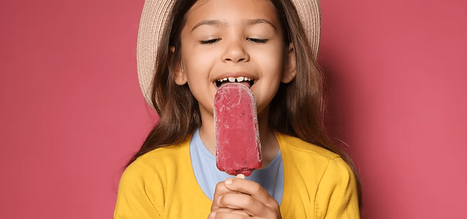 Young girl eating popsicle